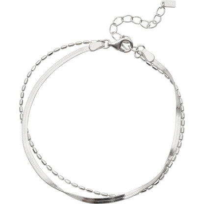 Silver bracelet with a double chain link design on a white background