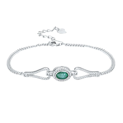 Silver bracelet with a green emerald gemstone and white zirconia stones on a white background