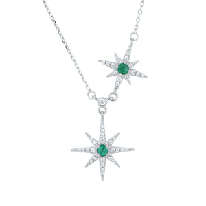 Silver necklace with star-shaped pendants featuring green emerald gemstones on a white background