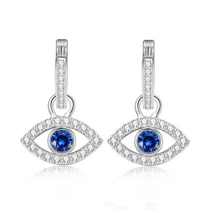 Pair of silver eye-shaped earrings with blue and white gemstones on a white background