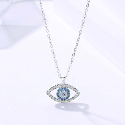 Silver necklace with an eye-shaped pendant featuring blue stones on a white background