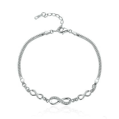 Silver bracelet with infinity design on a white background