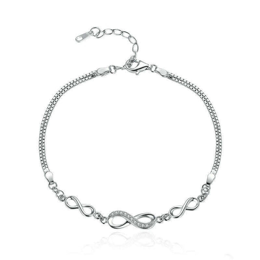 Silver bracelet with infinity design on a white background