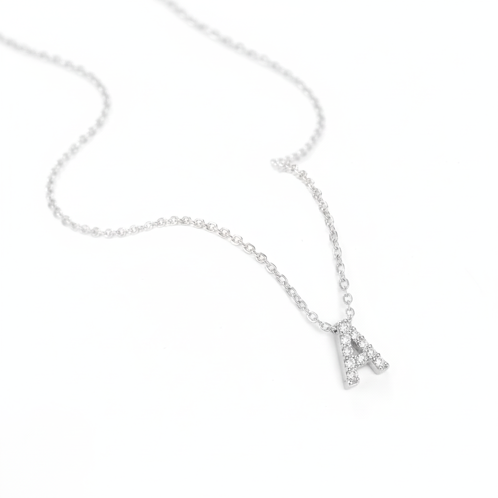 Silver necklace with a small letter 'A' pendant on a white background