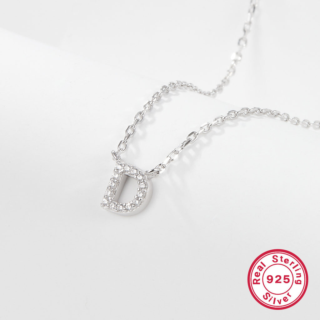 Silver necklace with a 'D' pendant on a light gray background, featuring a 'Real Sterling Silver 925' stamp.