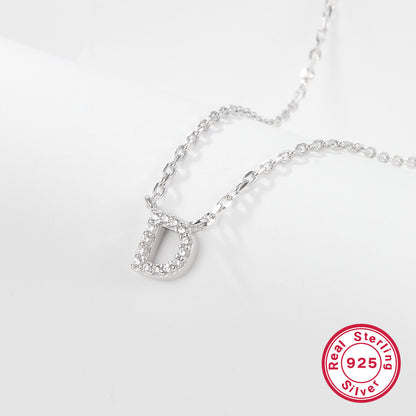 Silver necklace with a 'D' pendant on a light gray background, featuring a 'Real Sterling Silver 925' stamp.