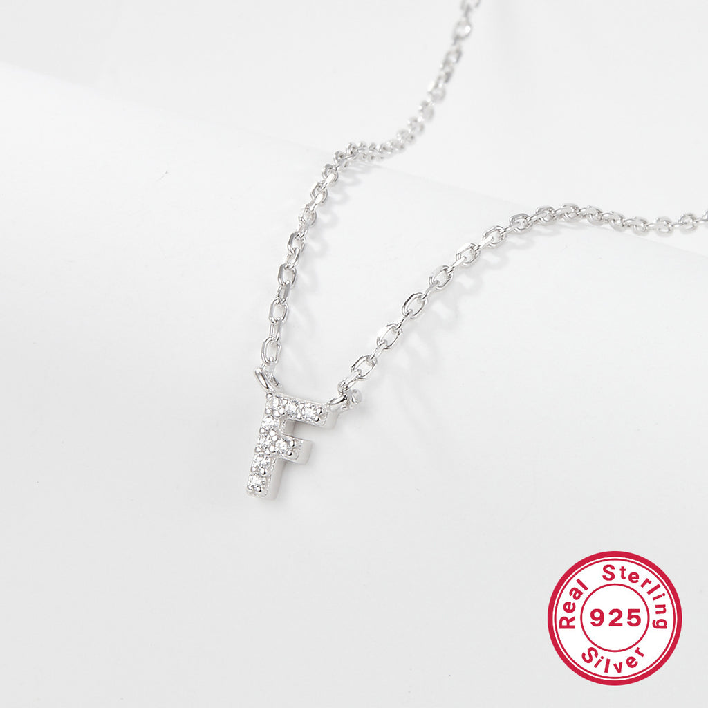 Silver necklace with a letter 'F' pendant on a white background, featuring a 'Real Sterling Silver 925' stamp.