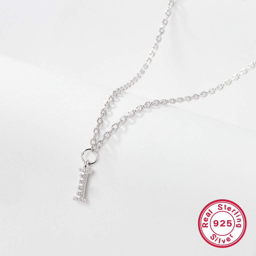 Silver necklace with a letter 'I' pendant on a white background, featuring a 'Real Sterling Silver 925' stamp.