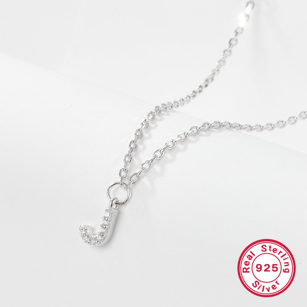 Silver necklace with a letter 'J' pendant on a white background, featuring a 'Real Sterling Silver 925' stamp.