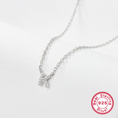 Silver necklace with a letter 'K' pendant on a white background, featuring a 'Real Sterling Silver 925' stamp.