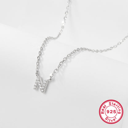 Silver necklace with a letter 'N' pendant on a white background, featuring a 'Real Sterling Silver 925' stamp.