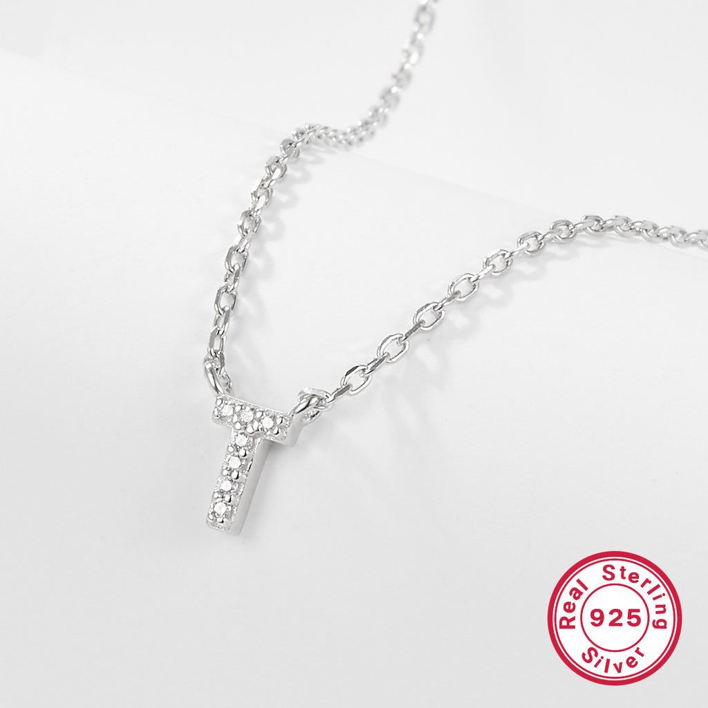 Silver necklace with a letter 'T' pendant on a white background, featuring a 'Real Sterling Silver 925' stamp.