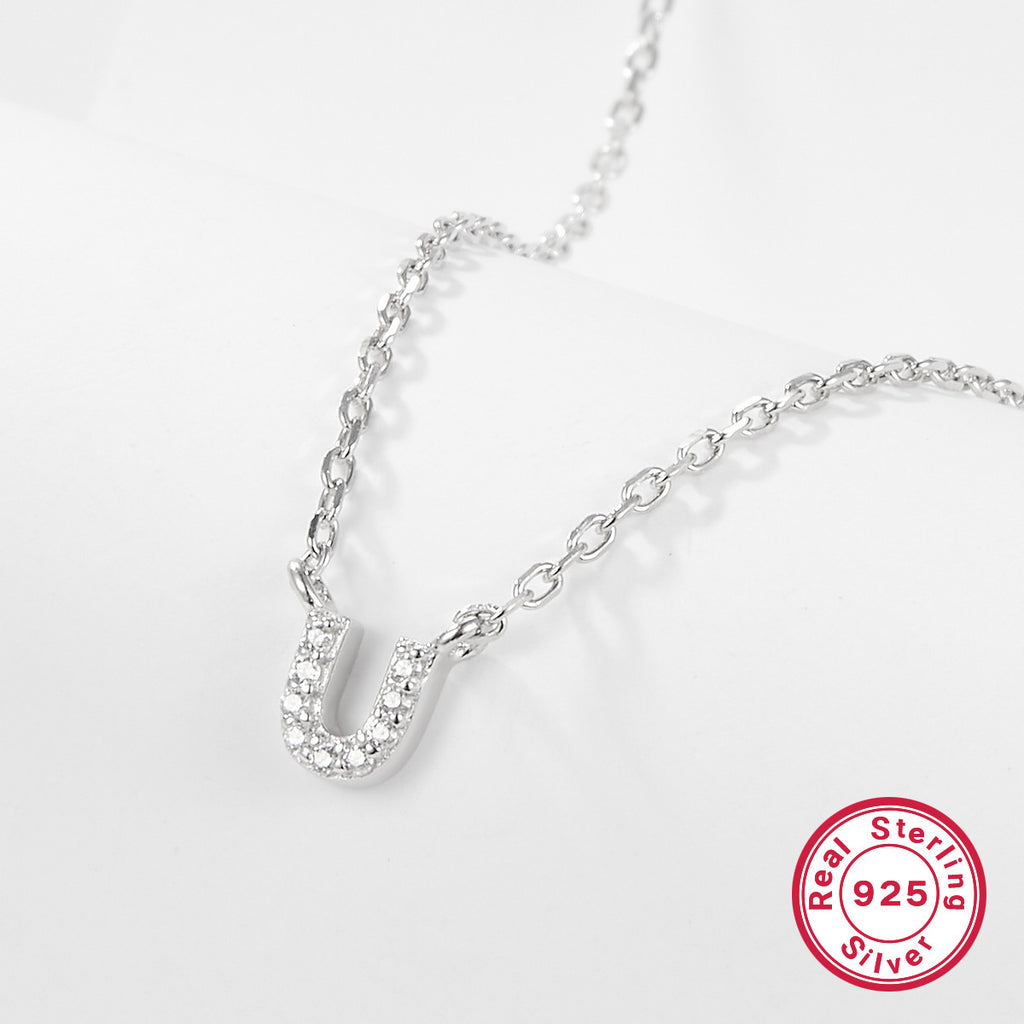 Silver necklace with a letter 'U' pendant on a white background, featuring a 'Real Sterling Silver 925' stamp.