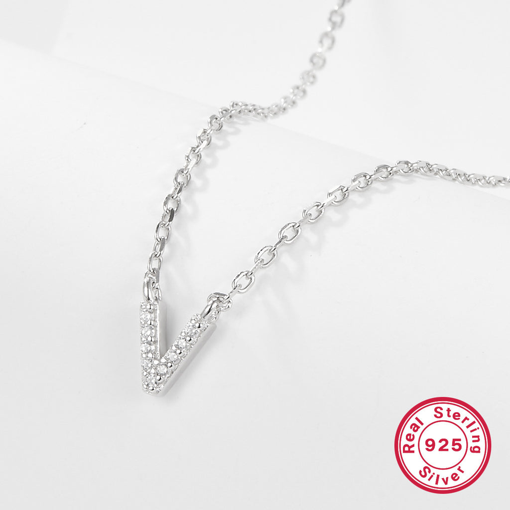 Silver necklace with a V-shaped pendant on a light gray background, featuring a 'Real Sterling Silver 925' stamp.