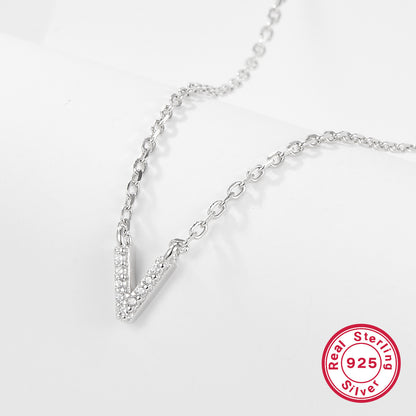 Silver necklace with a V-shaped pendant on a light gray background, featuring a 'Real Sterling Silver 925' stamp.