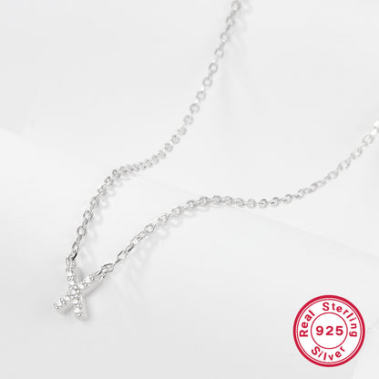Silver necklace with a letter 'X' pendant on a white background, featuring a 'Real Sterling Silver 925' stamp.