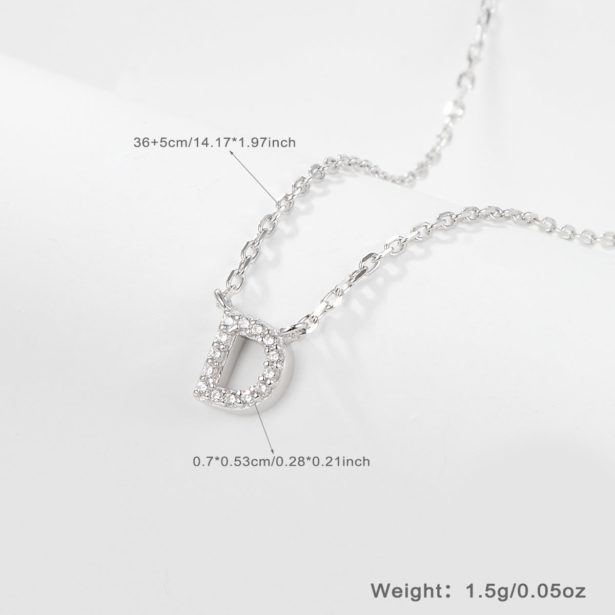 Silver necklace with a letter 'D' pendant on a white background and size specifications
