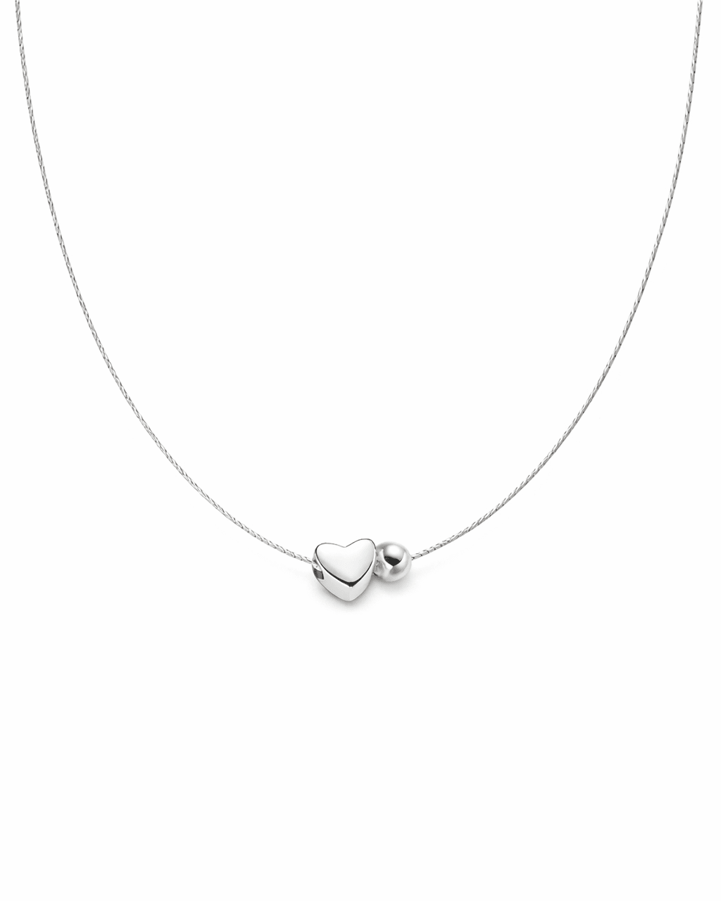 Silver necklace with a heart-shaped pendant on a white background