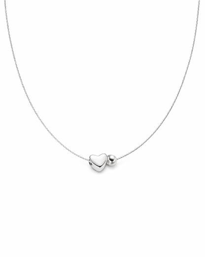 Silver necklace with a heart-shaped pendant on a white background