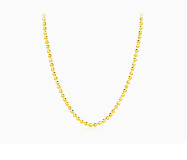 Gold plated beaded necklace on a white background