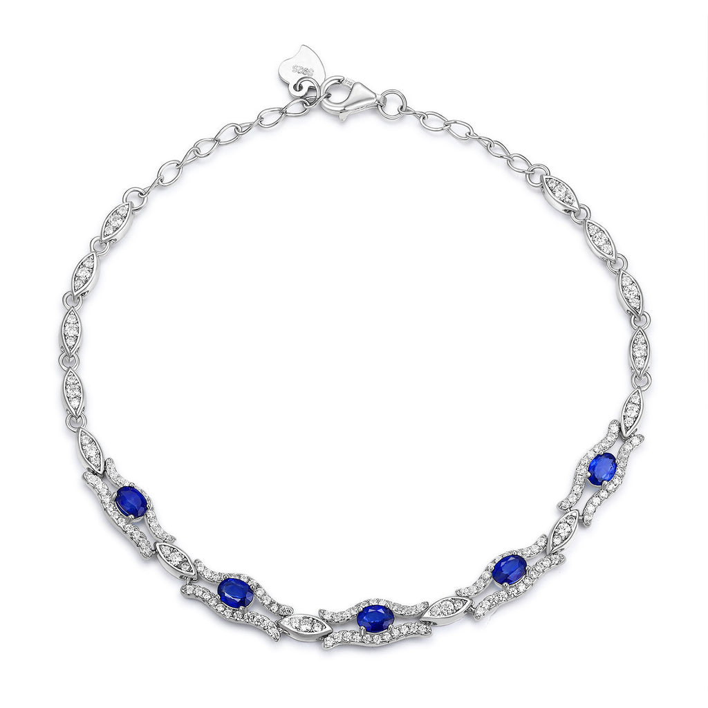 Silver bracelet with natural blue sapphire gemstones on a white background