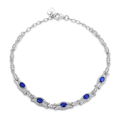 Silver bracelet with natural blue sapphire gemstones on a white background