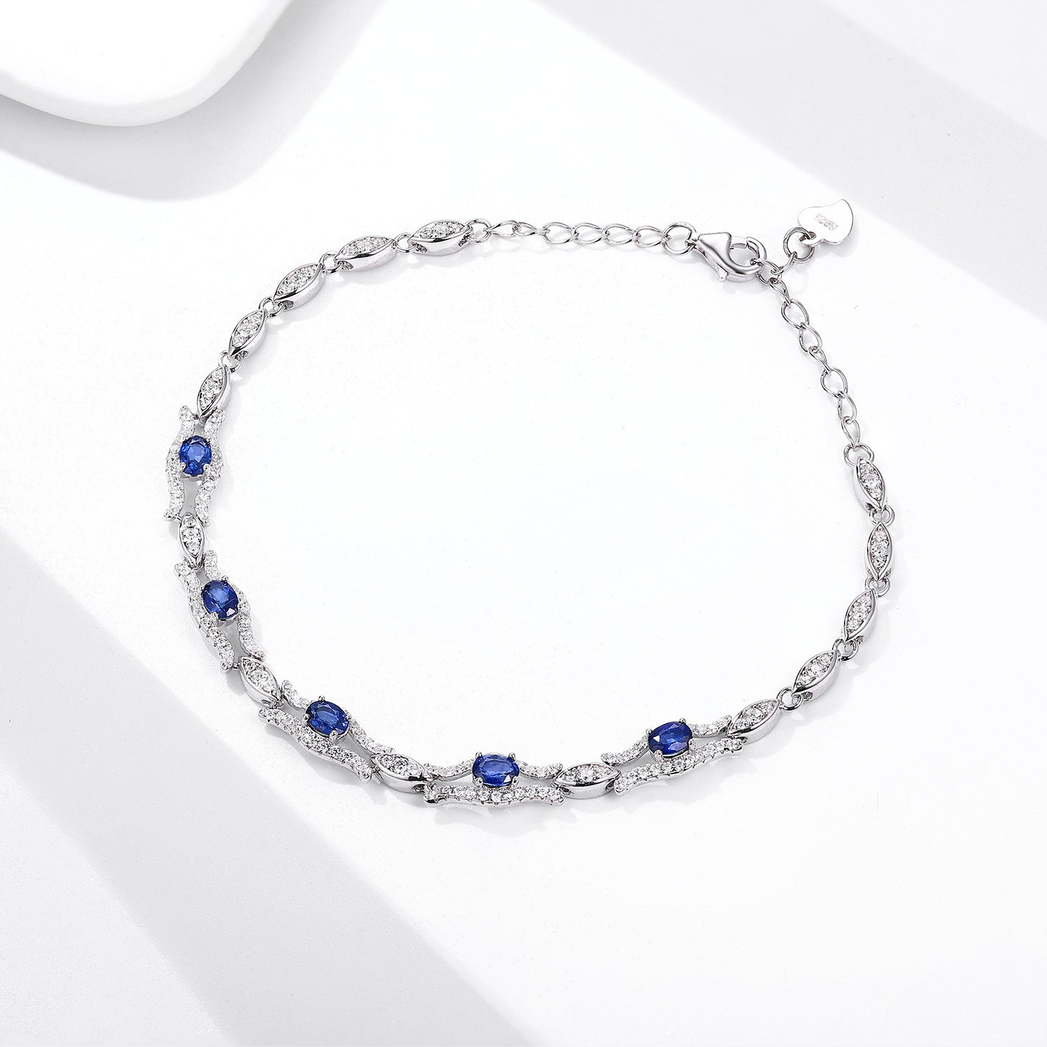 Silver bracelet with natural blue sapphire gemstones on a white background