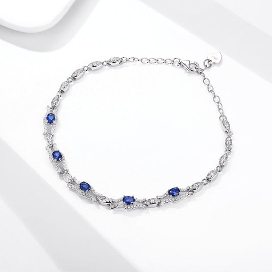 Silver bracelet with natural blue sapphire gemstones on a white background