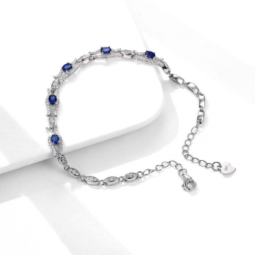 Silver bracelet with natural blue sapphire stones on a white background
