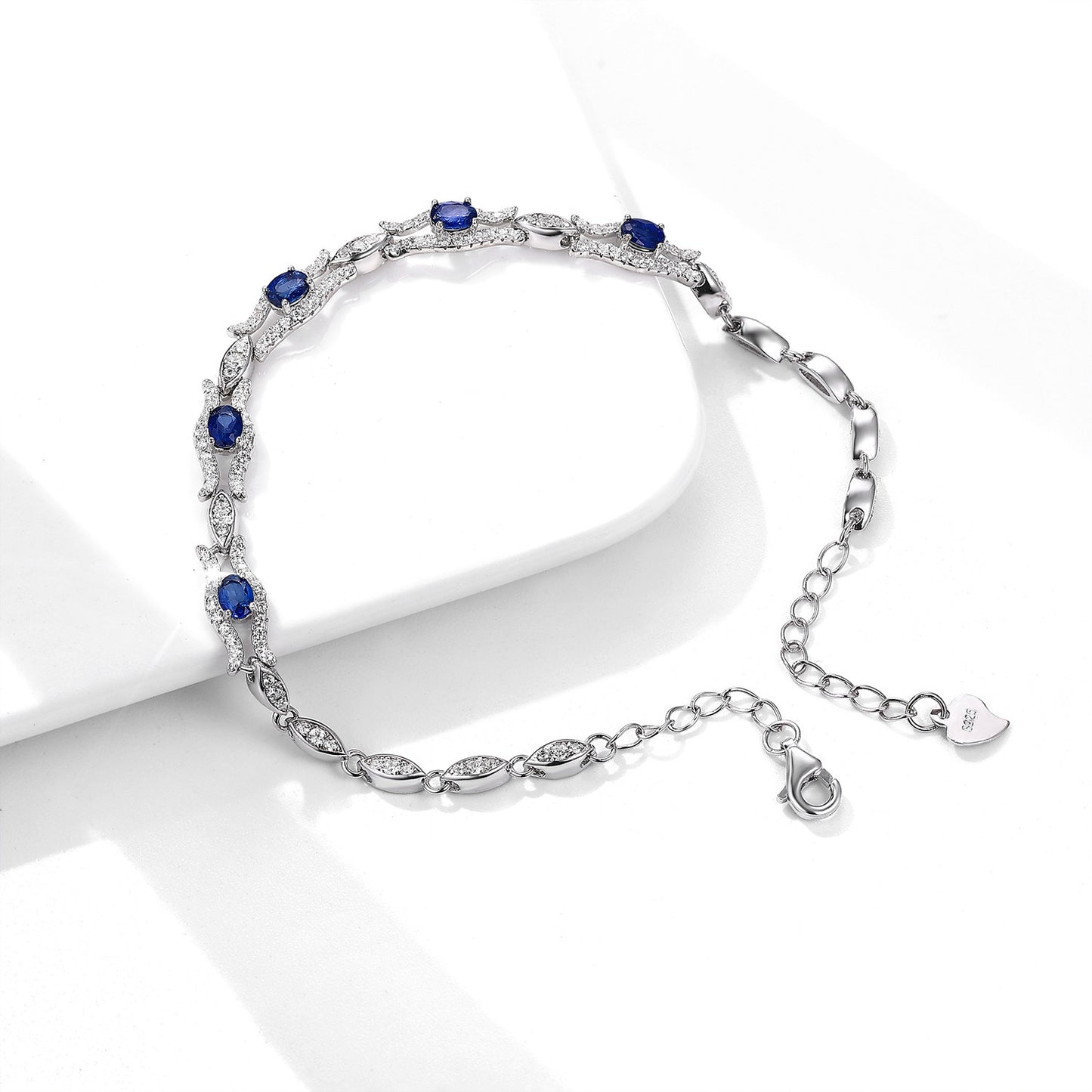 Silver bracelet with natural blue sapphire stones on a white background