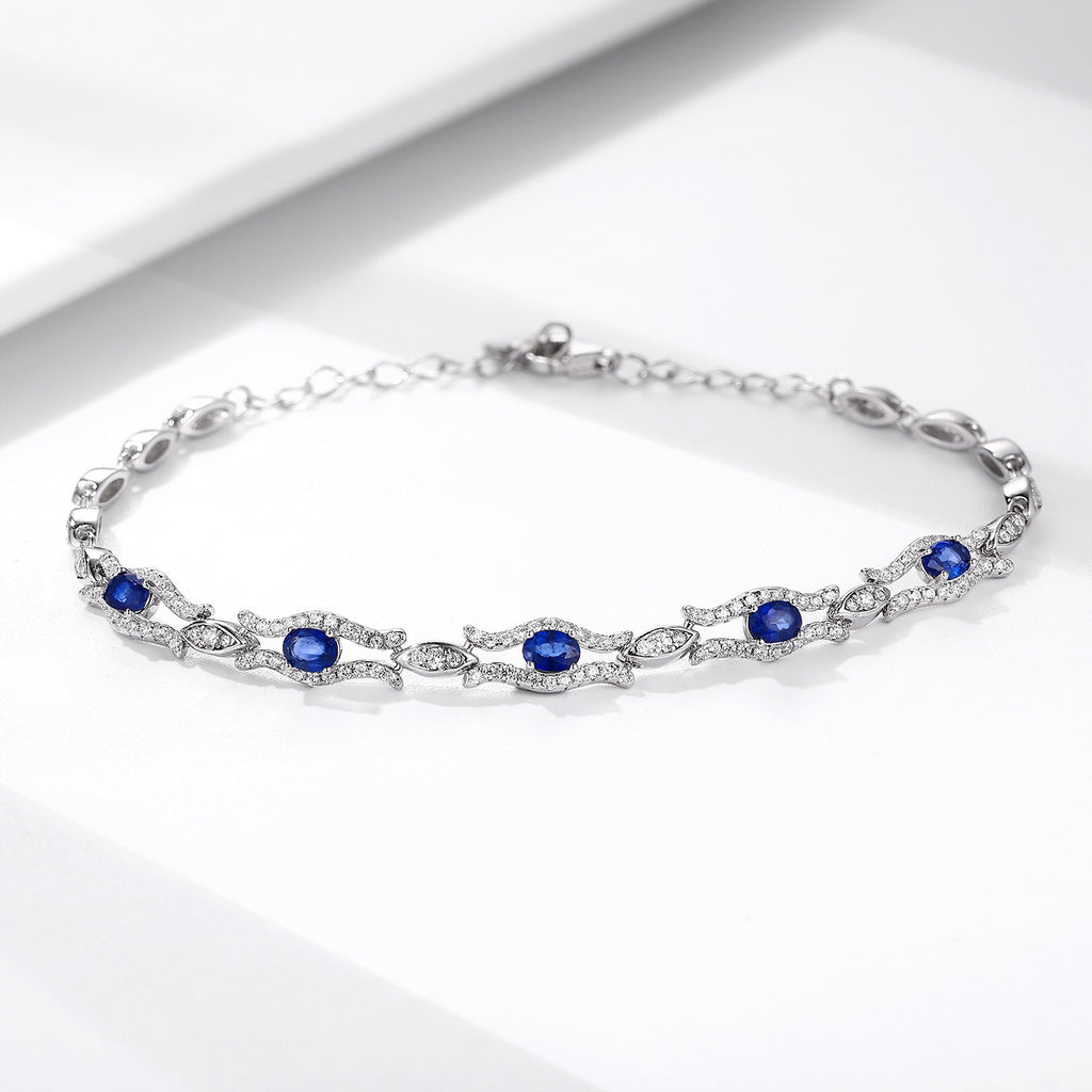 Silver bracelet with natural blue sapphire gemstones on a white background