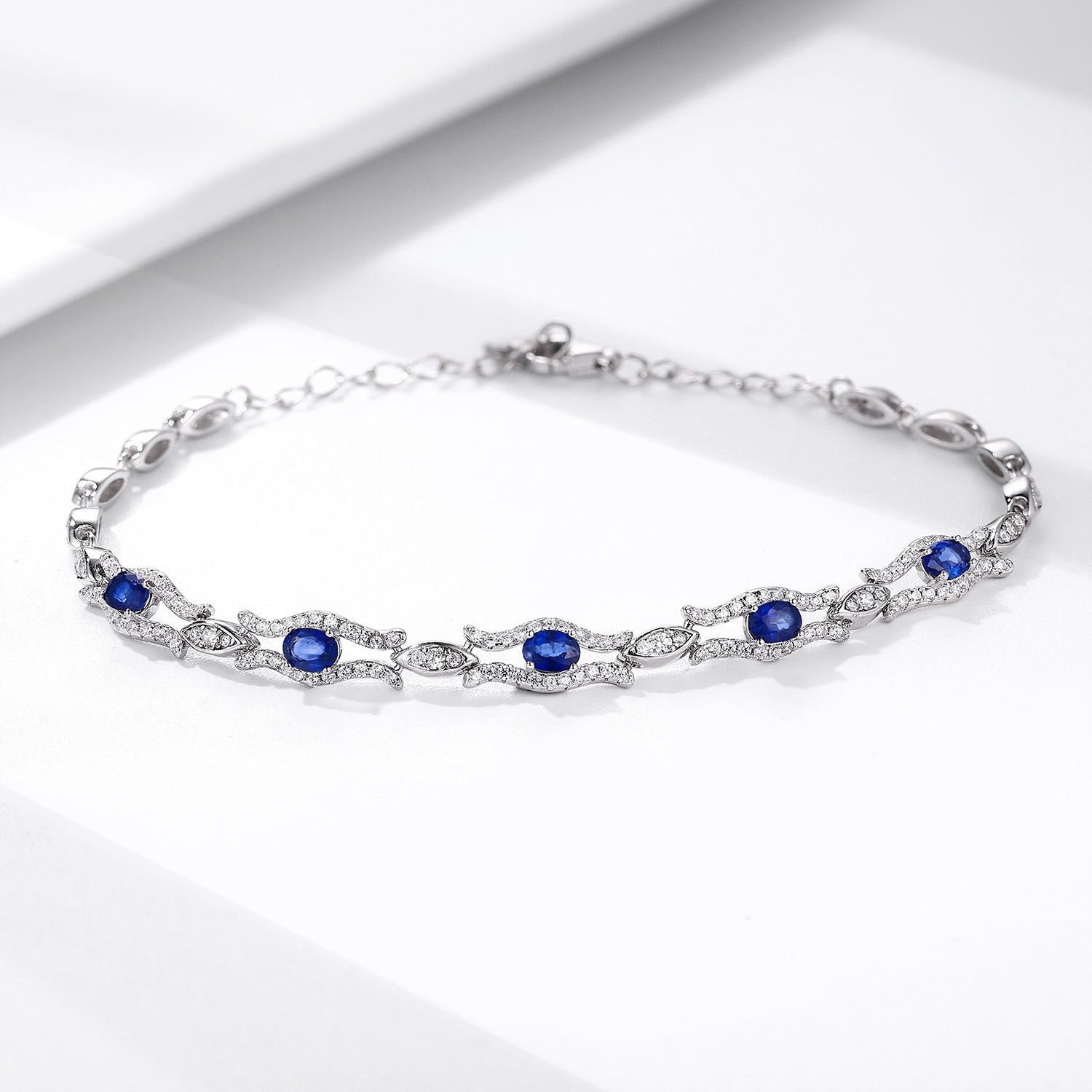 Silver bracelet with natural blue sapphire gemstones on a white background