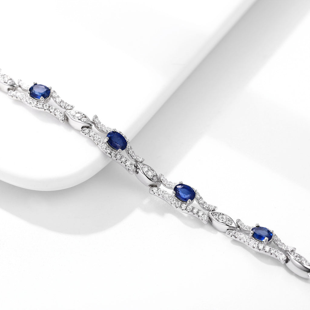 Silver bracelet with natural blue sapphire gemstones on a white background