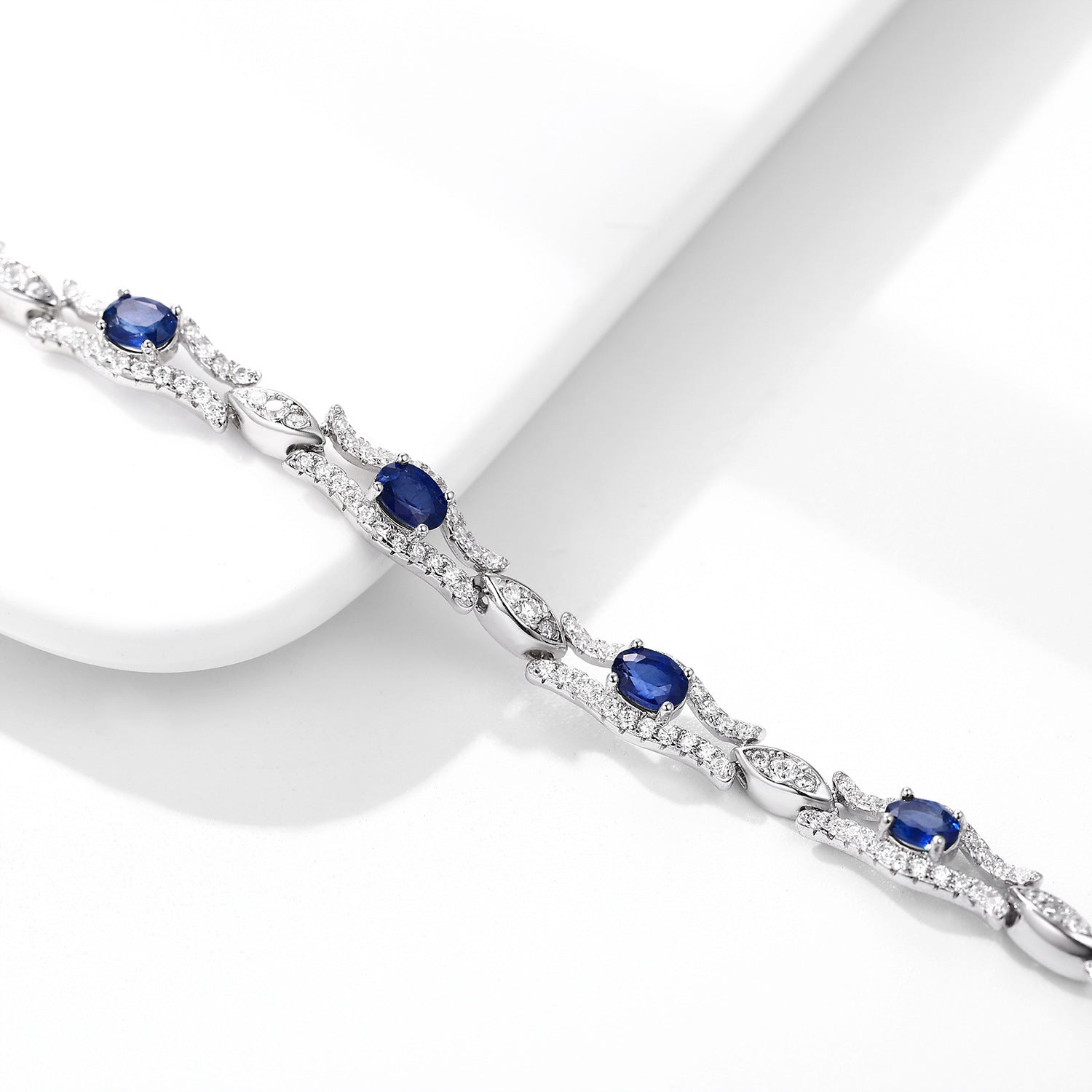 Silver bracelet with natural blue sapphire gemstones on a white background