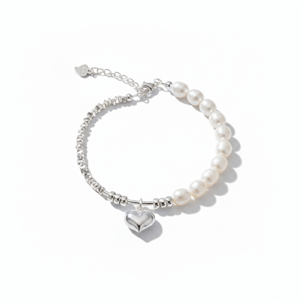 Pearl bracelet with a heart charm and silver beads on a white background