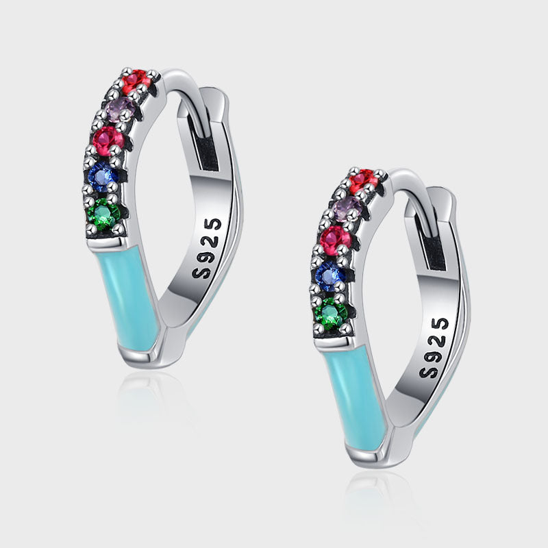 Silver hoop earrings with colorful gemstones and light blue accents on a white background
