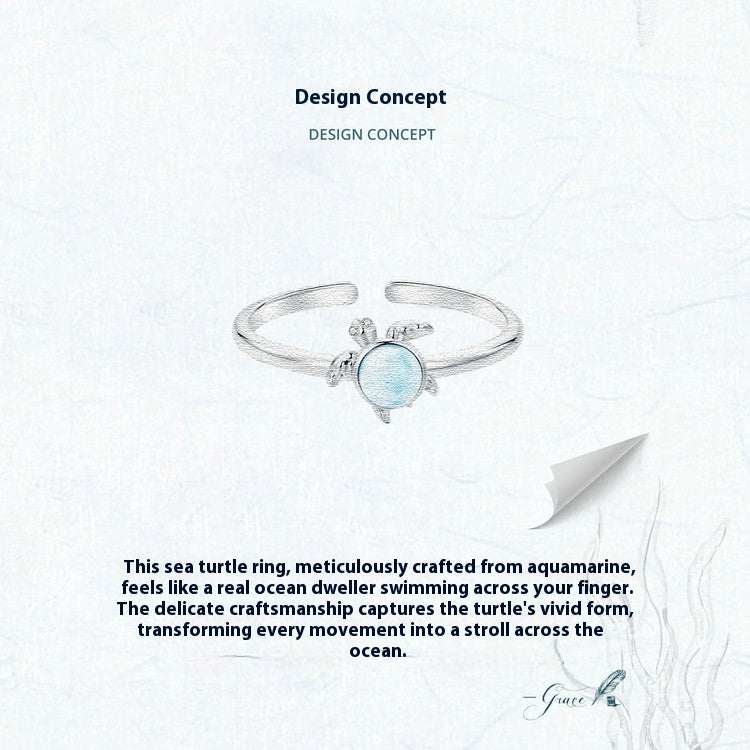 Sea turtle ring with aquamarine stone on a white background