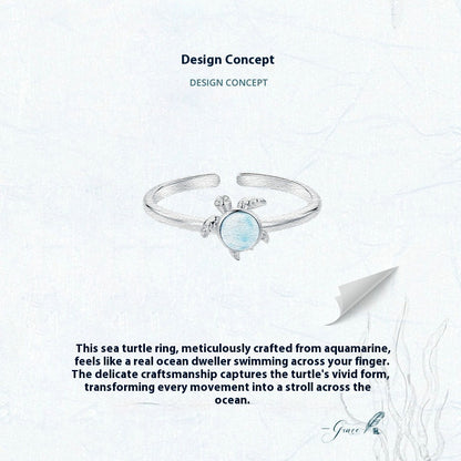Sea turtle ring with aquamarine stone on a white background