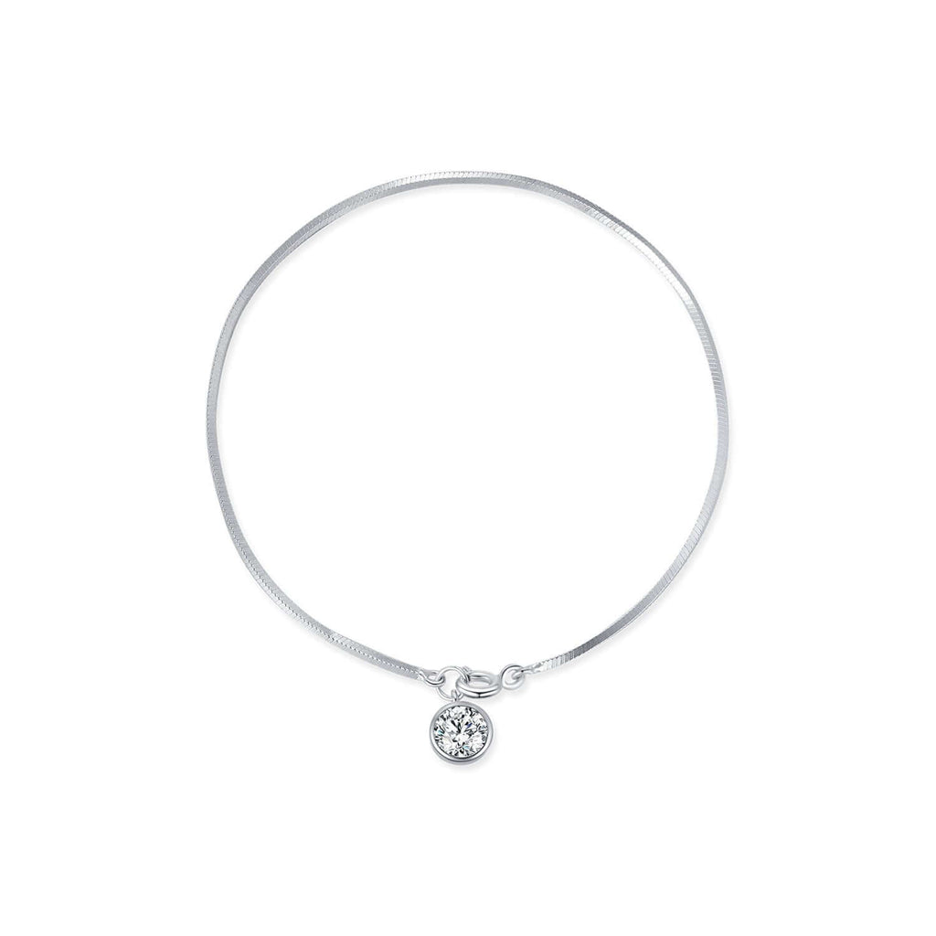 Silver bracelet with a small round pendant and snake chain on a white background