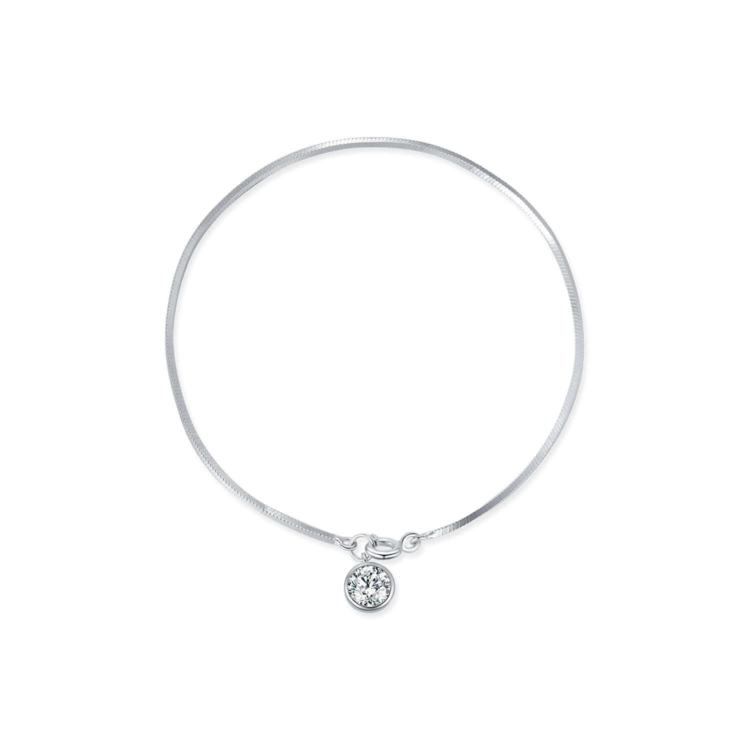 Silver bracelet with a small round pendant and snake chain on a white background