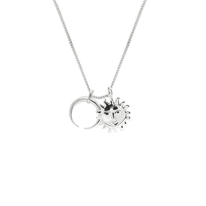 Silver necklace with sun and moon pendants on a white background