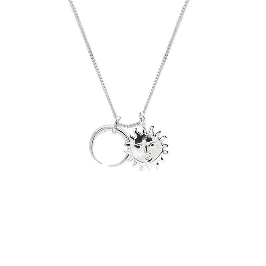 Silver necklace with sun and moon pendants on a white background