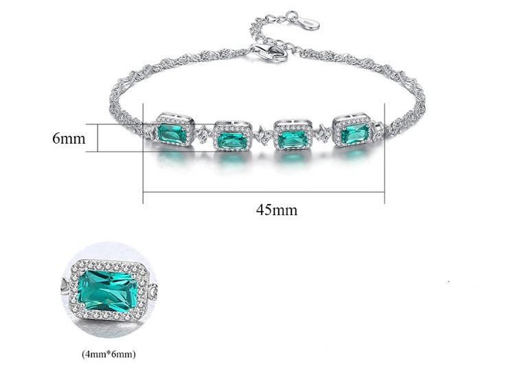 Bracelet with green gemstones and measurements on a white background