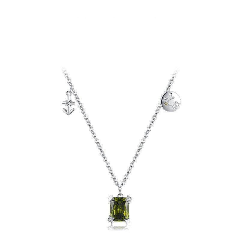 Necklace with a green gemstone pendant on a white background