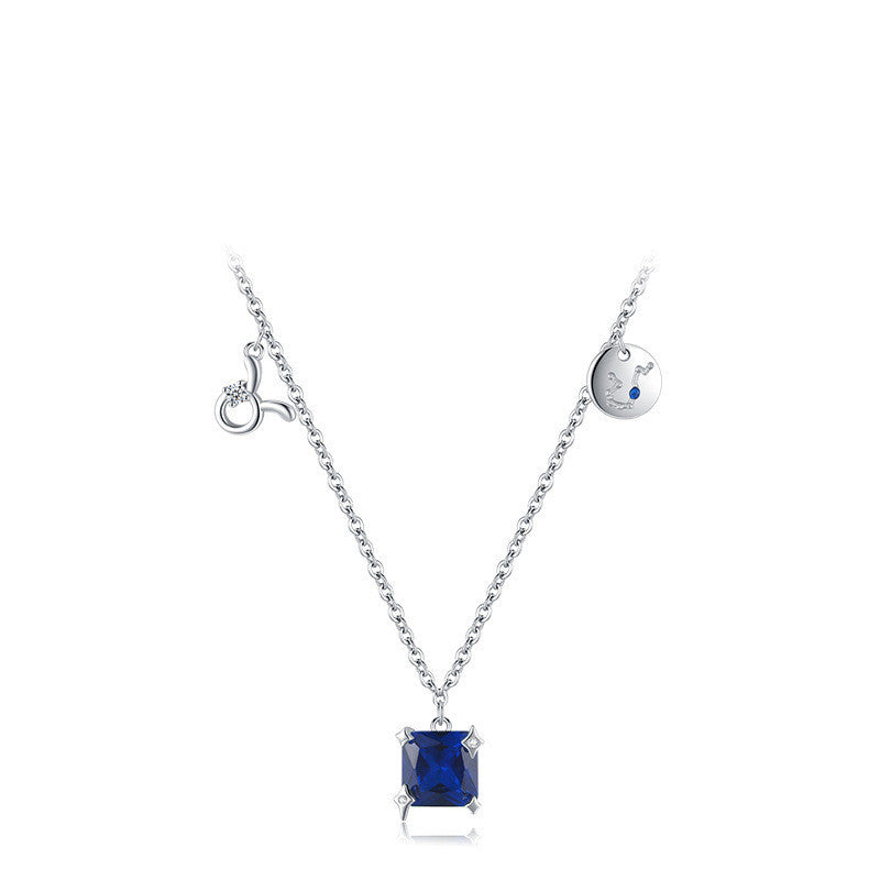 Silver necklace with a square blue gemstone pendant on a white background