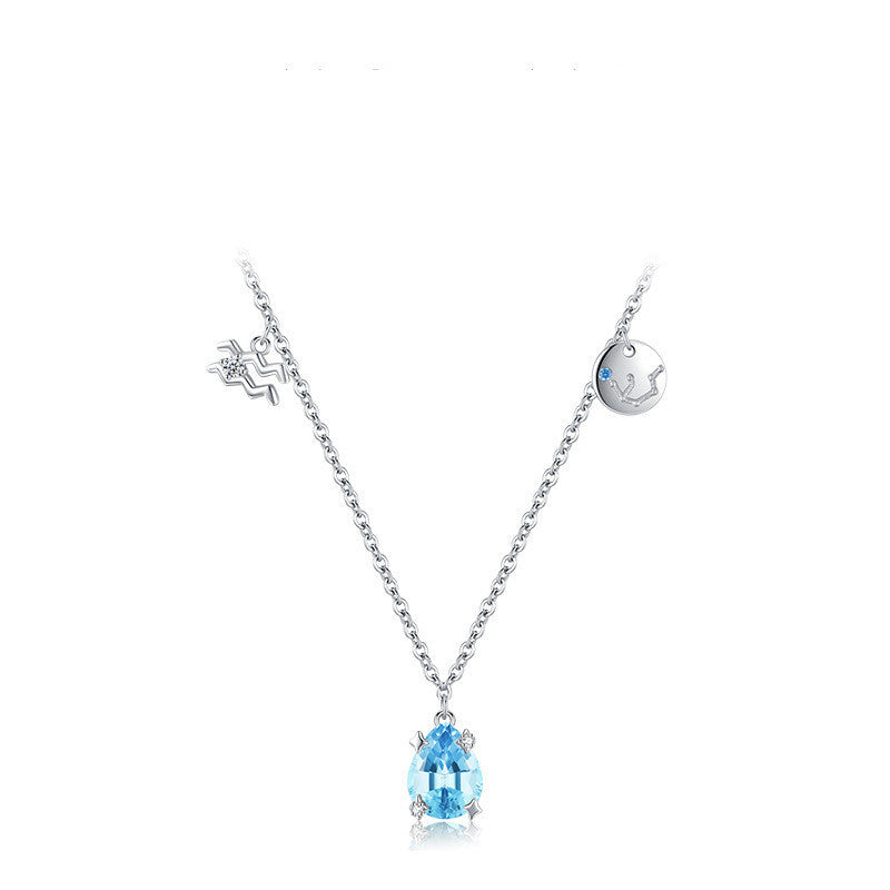 Silver necklace with a blue teardrop pendant on a white background