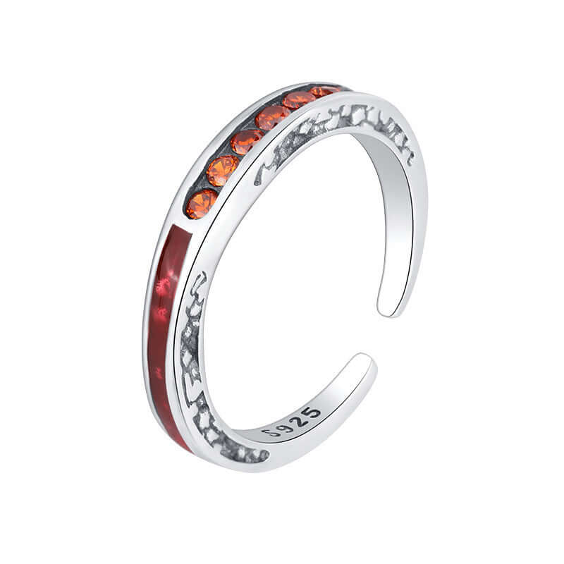 Silver ring with orange zircon gemstones on a white background