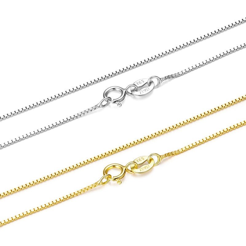 Two gold and silver box chain necklaces on a white background