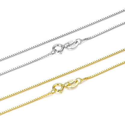 Two gold and silver box chain necklaces on a white background