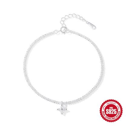 Silver bracelet with a flower charm on a white background, featuring a '925 sterling silver' stamp.